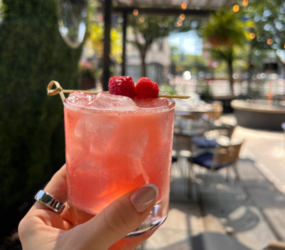 a hand holding a drink