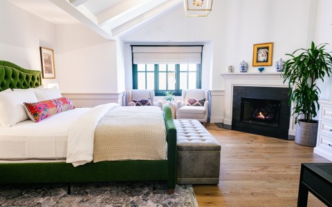 View of an Accessible Luxury Garden room at Fess Parker Wine Country Inn with fireplace in background