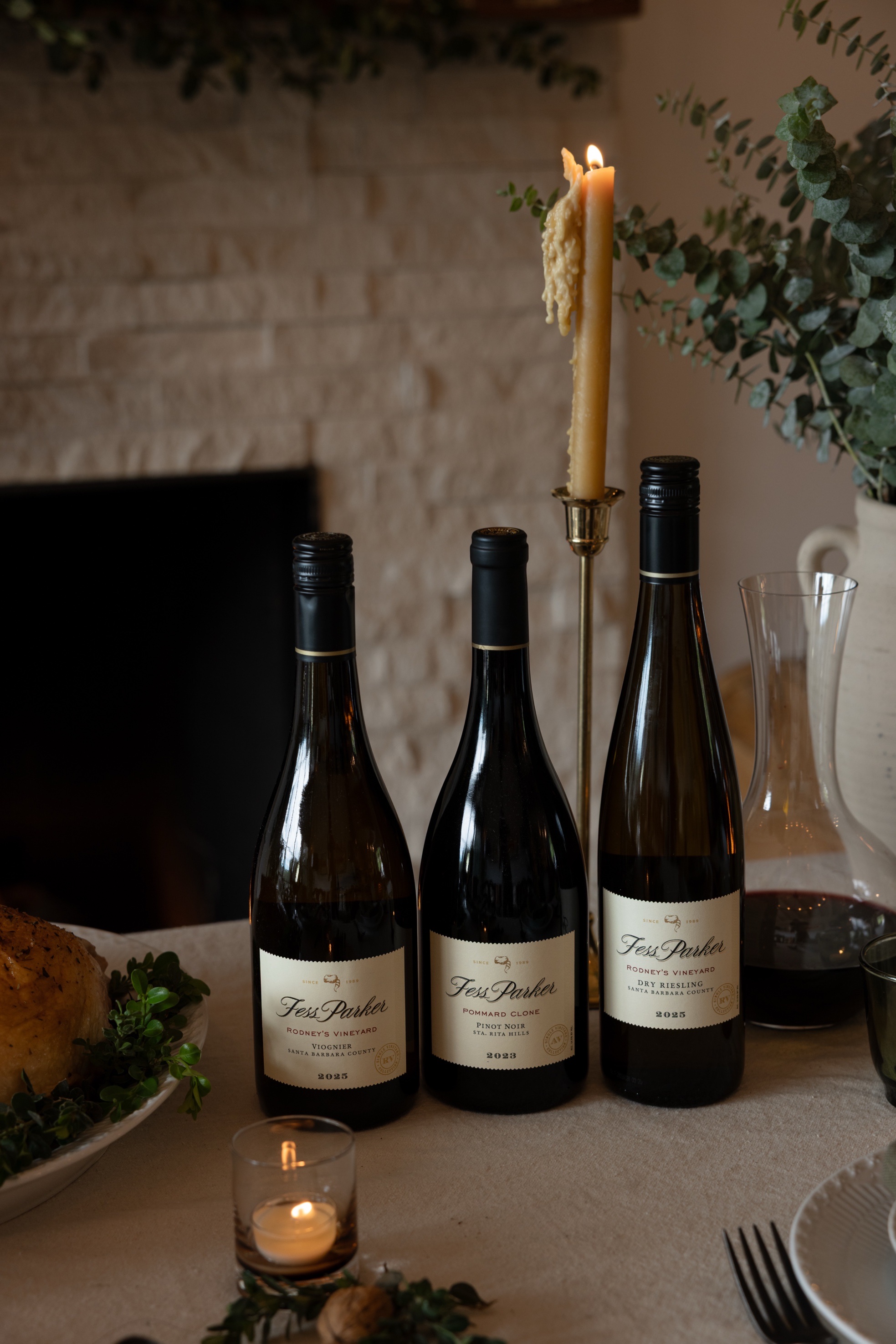 2025 Fess Parker Viognier, 2023 Fess Parker Pommard Clone Pinot Noir and 2025 Fess Parker Dry Riesling on a Thanksgiving table
