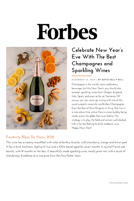 a bottle of champagne with fruits and nuts