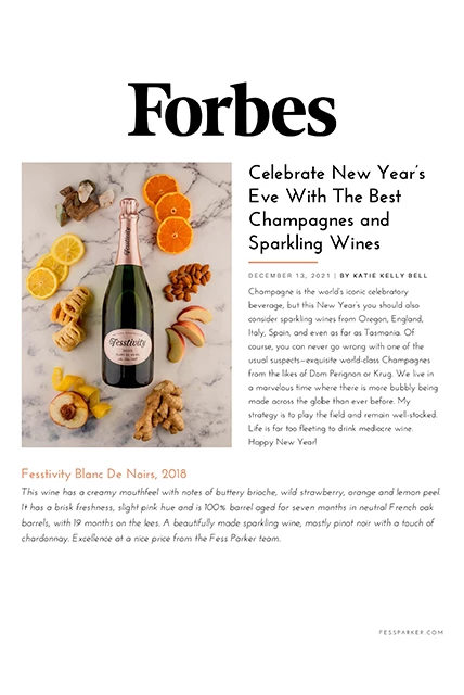 a bottle of champagne with fruits and nuts