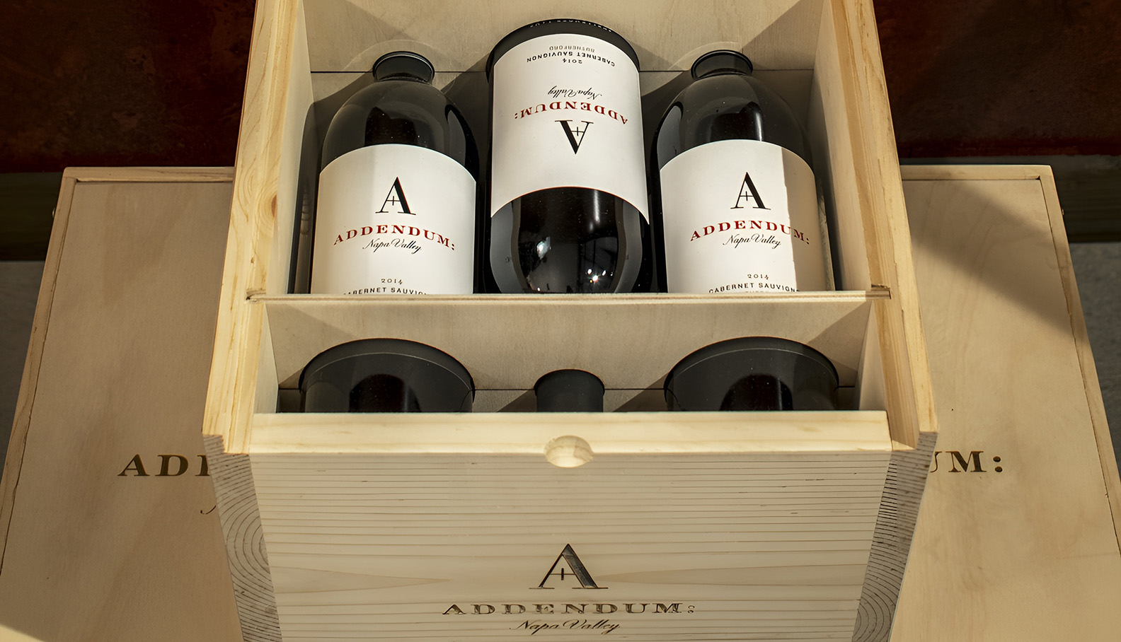 a wooden box with bottles in it