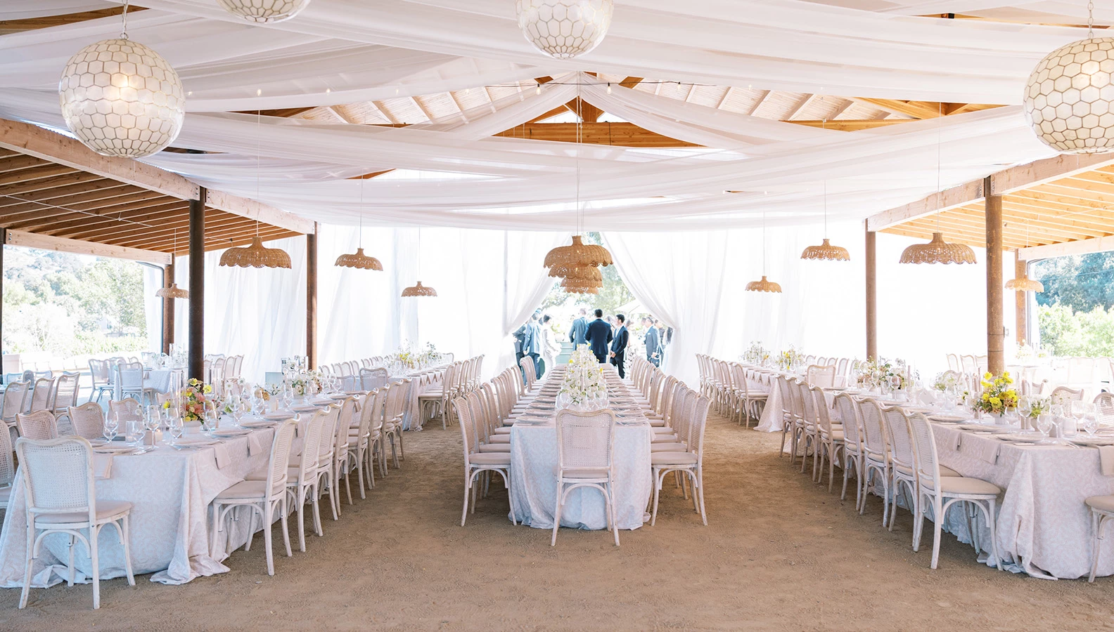 a large tent with tables and chairs