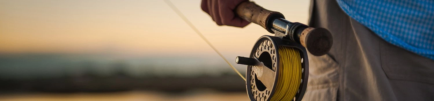 close up of a man holding a fishing pole