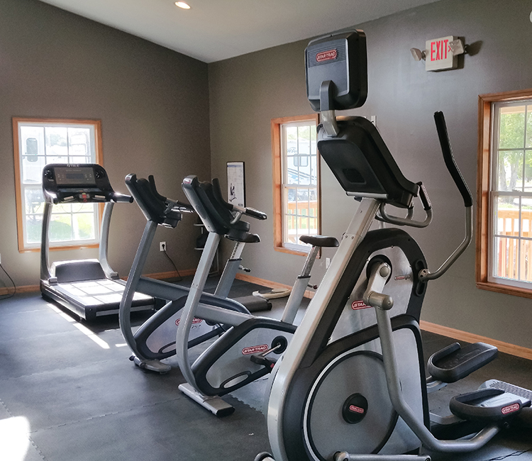 fitness center with ellipticals and treadmills