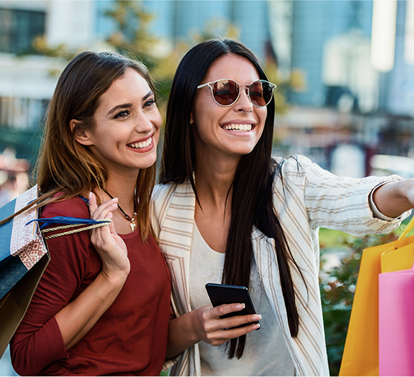 two women holding shopping bags