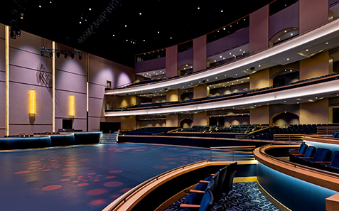 a large auditorium with seating and round floor