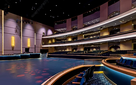 a large auditorium with seating and round floor