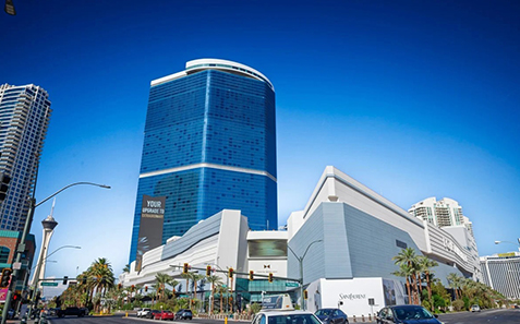 a large building with a lot of cars parked on the side
