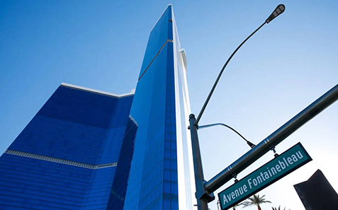 a tall building with a blue glass tower