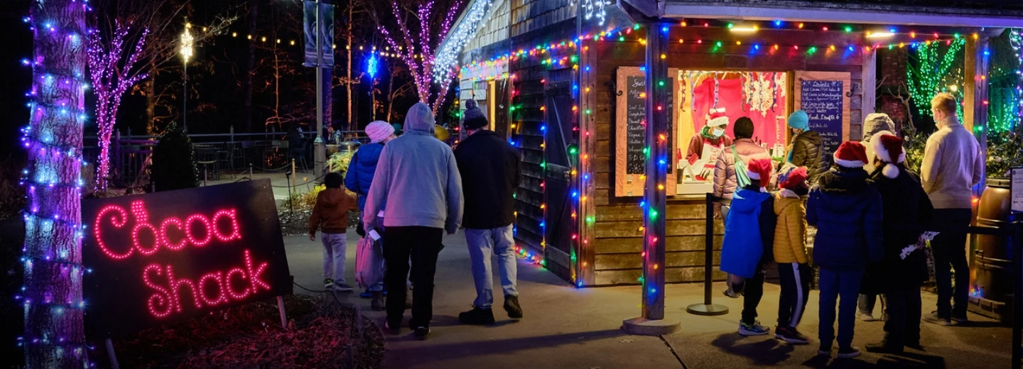 people walking on a sidewalk with a store in front of a store