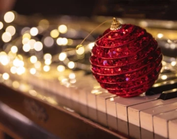 a red ornament on a piano
