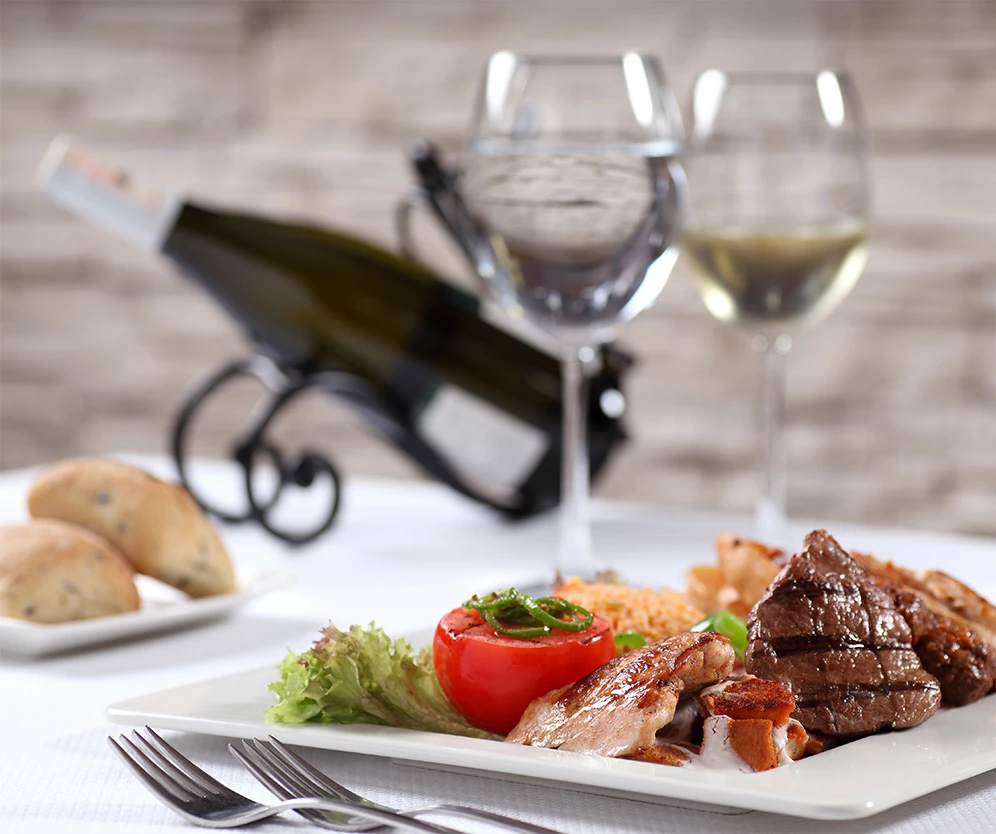 a plate of food and wine glasses