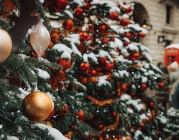 a tree with ornaments and snow