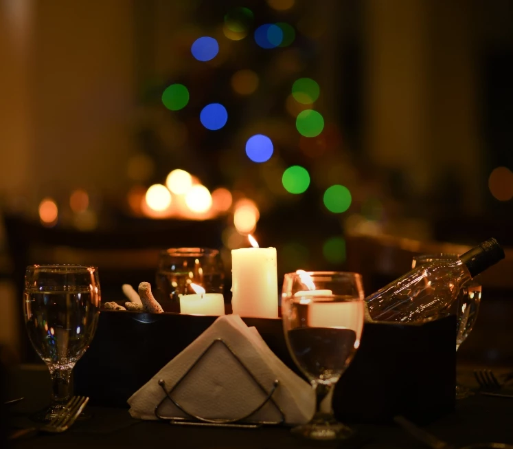 a table with wine glasses and candles