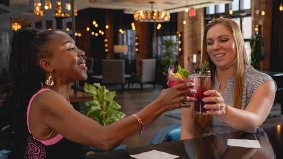a group of women holding drinks