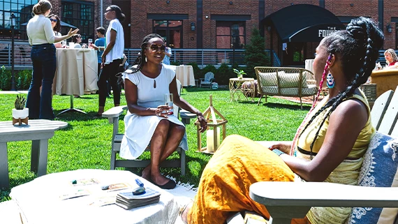 a woman sitting on a chair in a yard