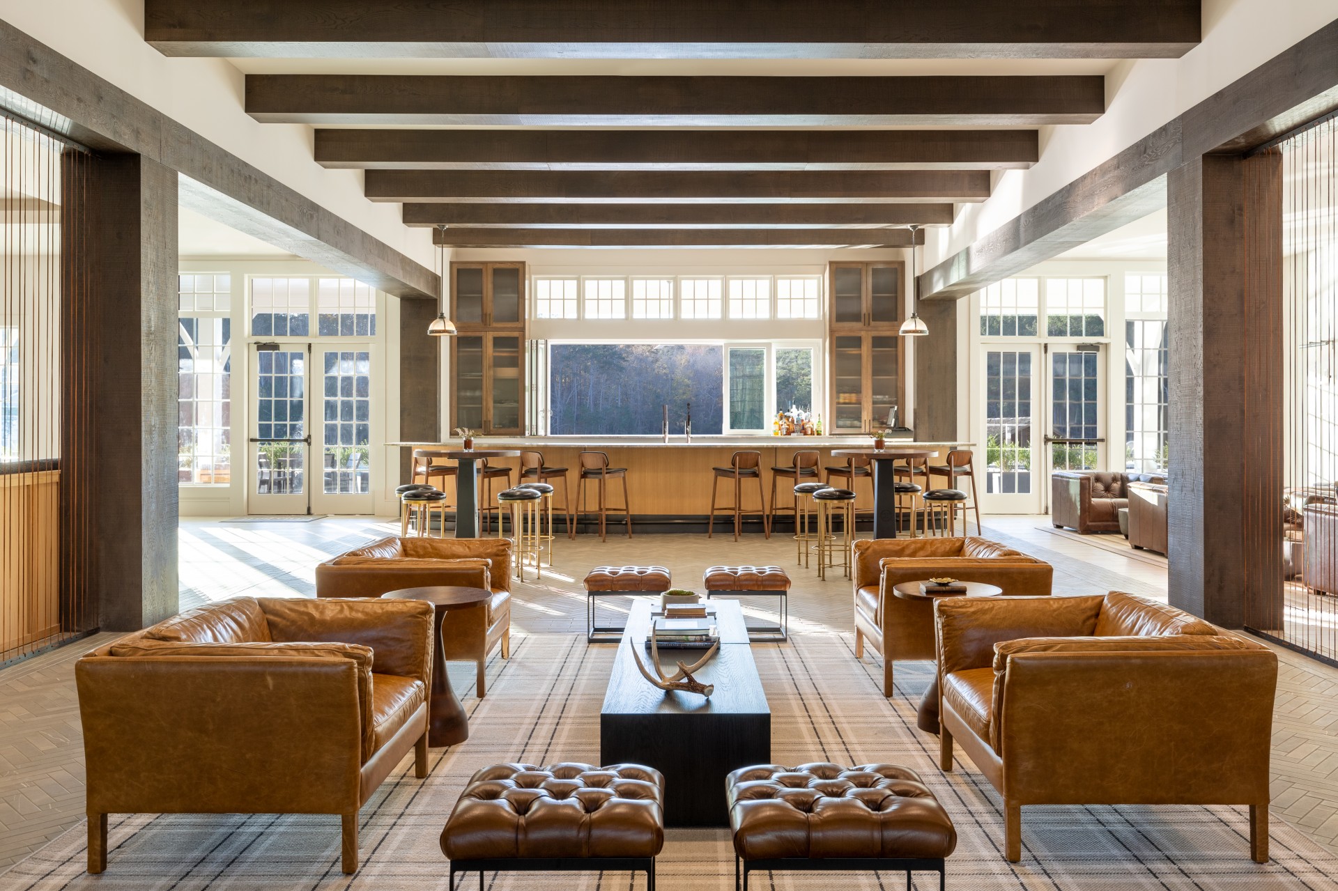 a room with leather furniture and a bar