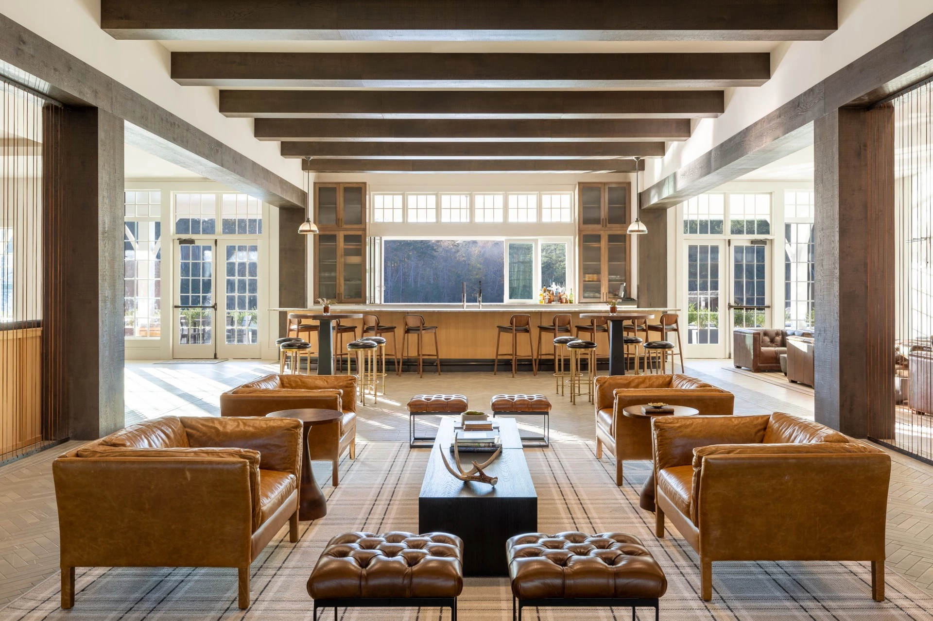 a room with leather furniture and a bar