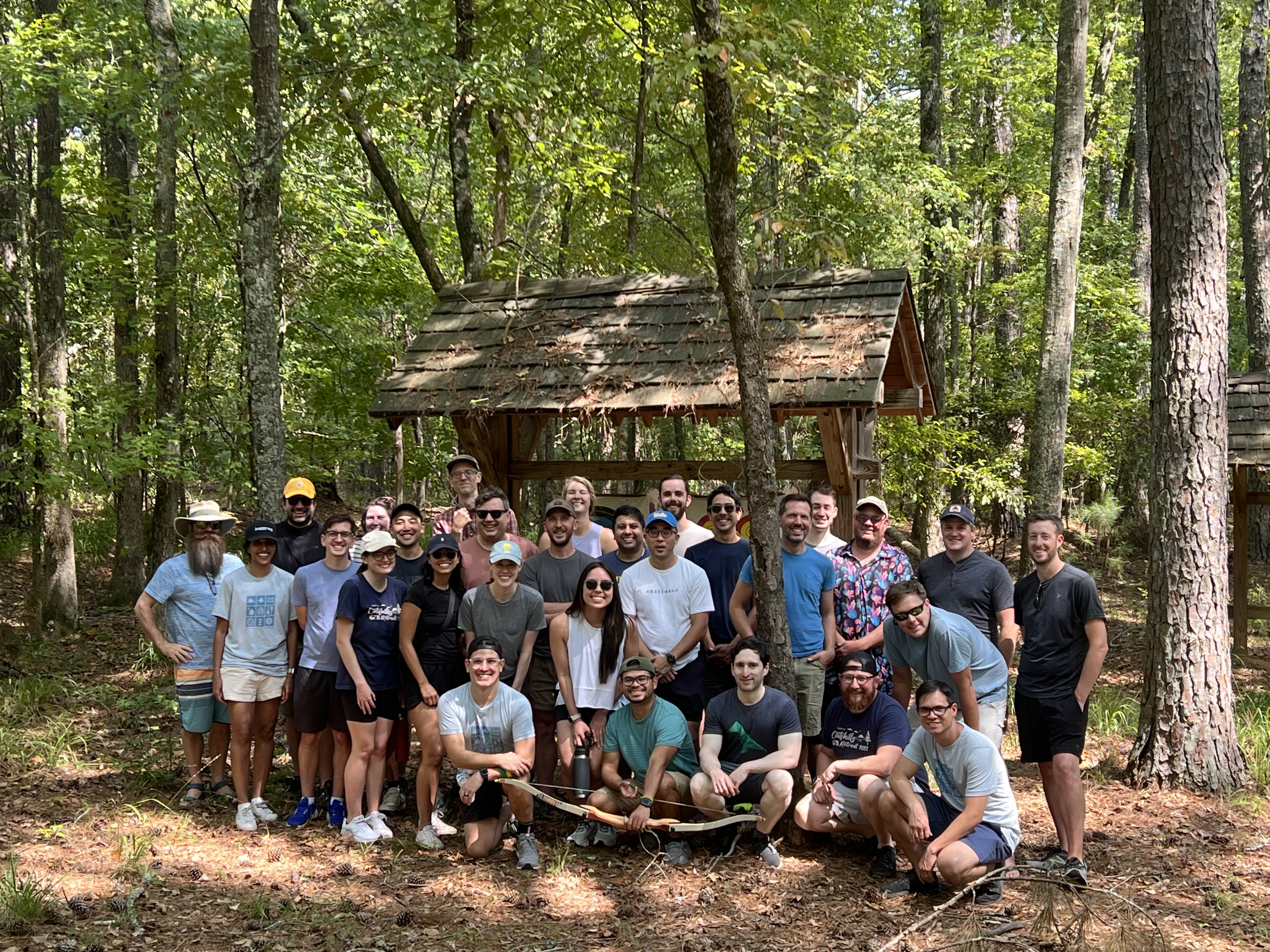 a group of people posing for a photo in the woods