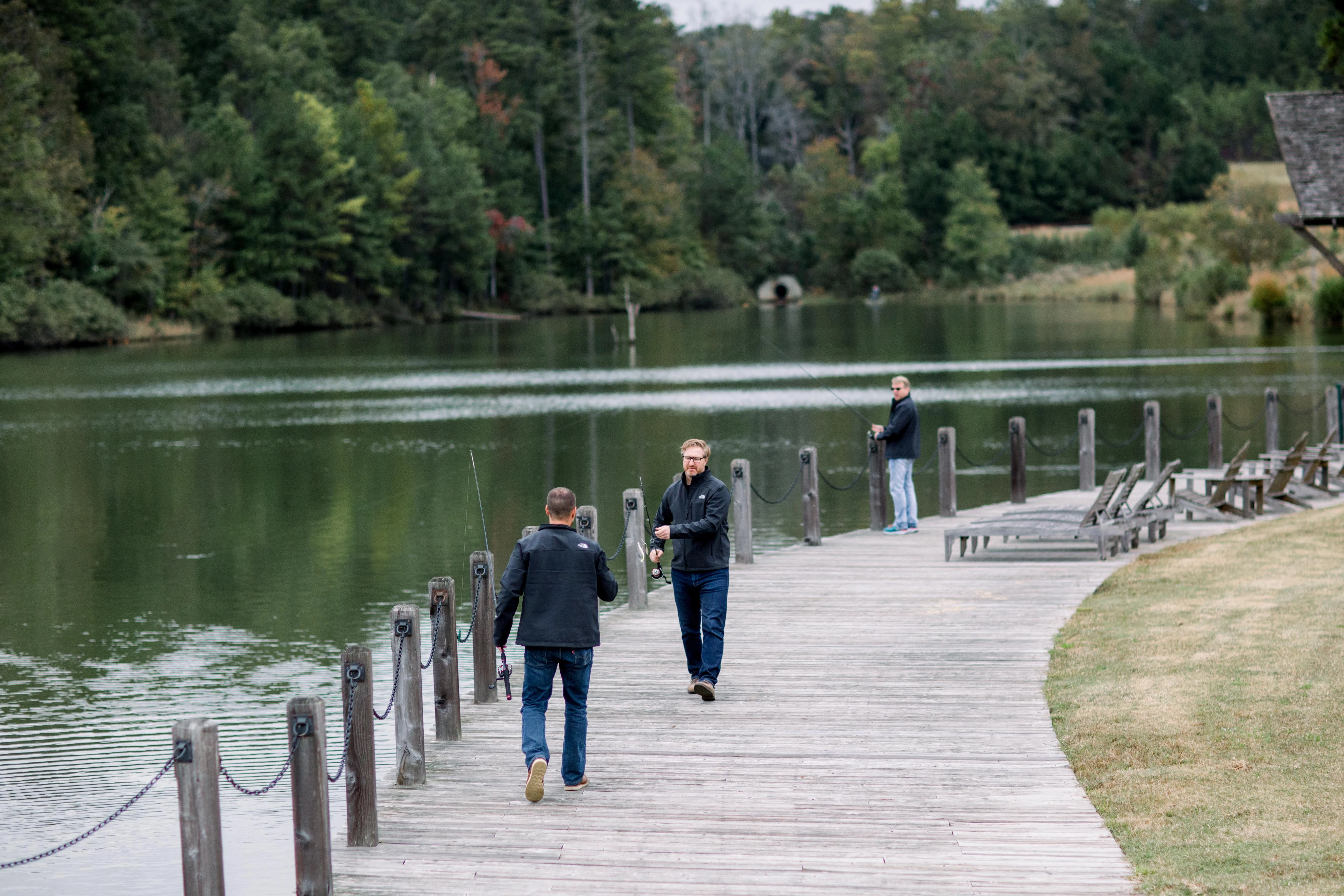 a group of men fishing on a dock