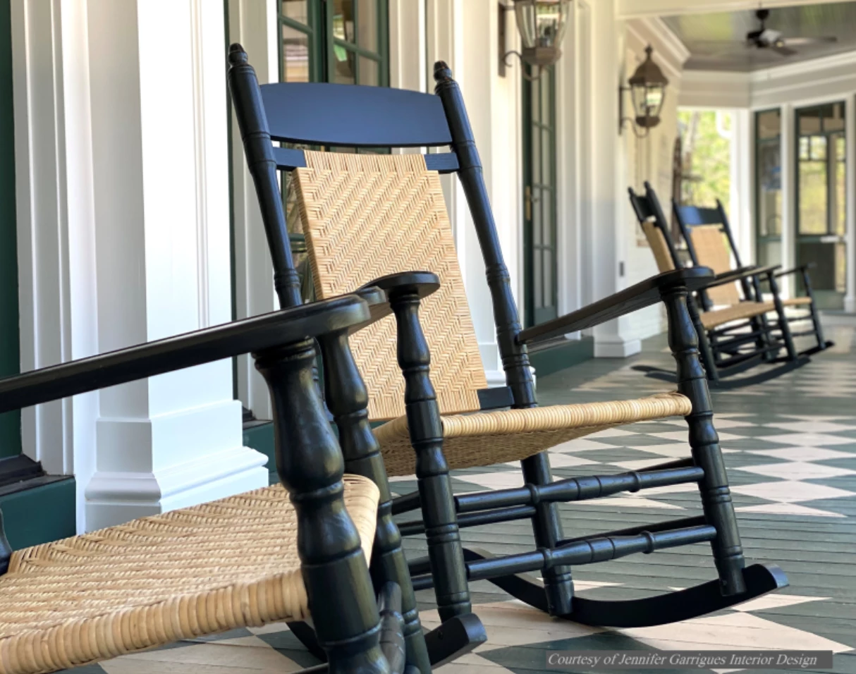 a group of rocking chairs on a porch