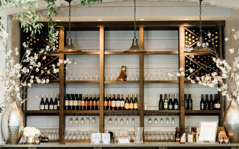 a bar with wine bottles and glasses