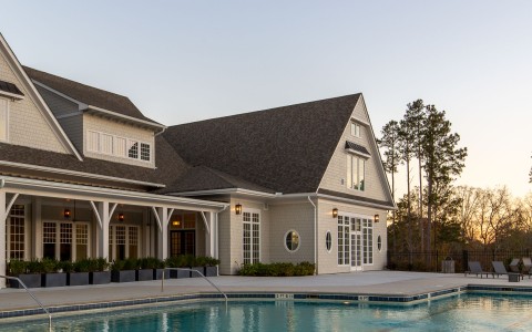 a swimming pool in front of a house