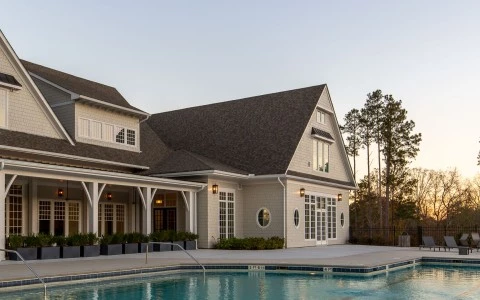 a swimming pool in front of a house