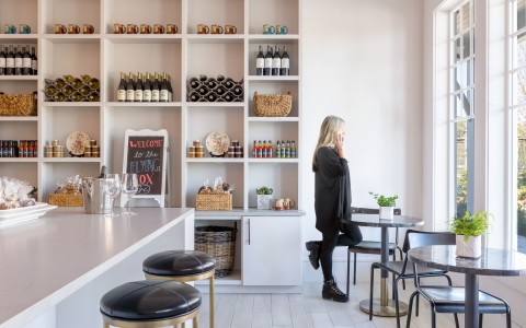 a woman sitting at a table in a bar