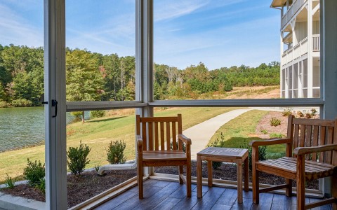 a porch with a view of a field and trees