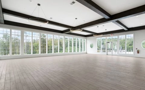 a large room with windows and wood floors