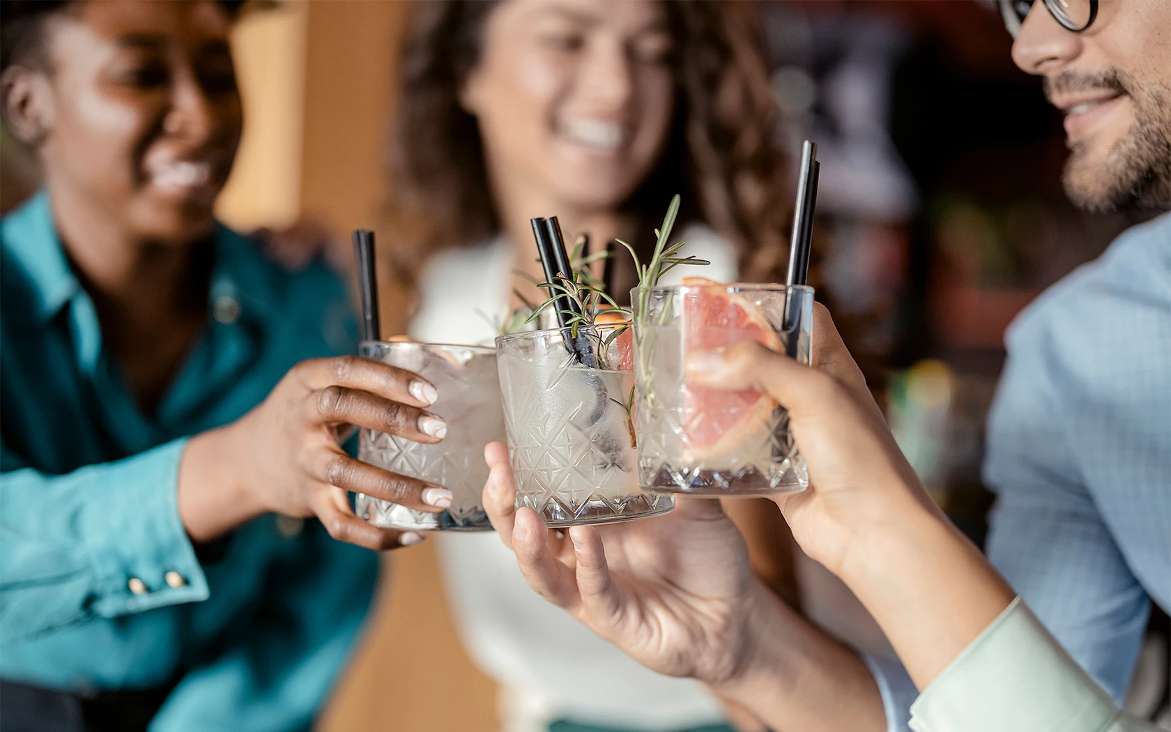 a group of people holding glasses up to cheers