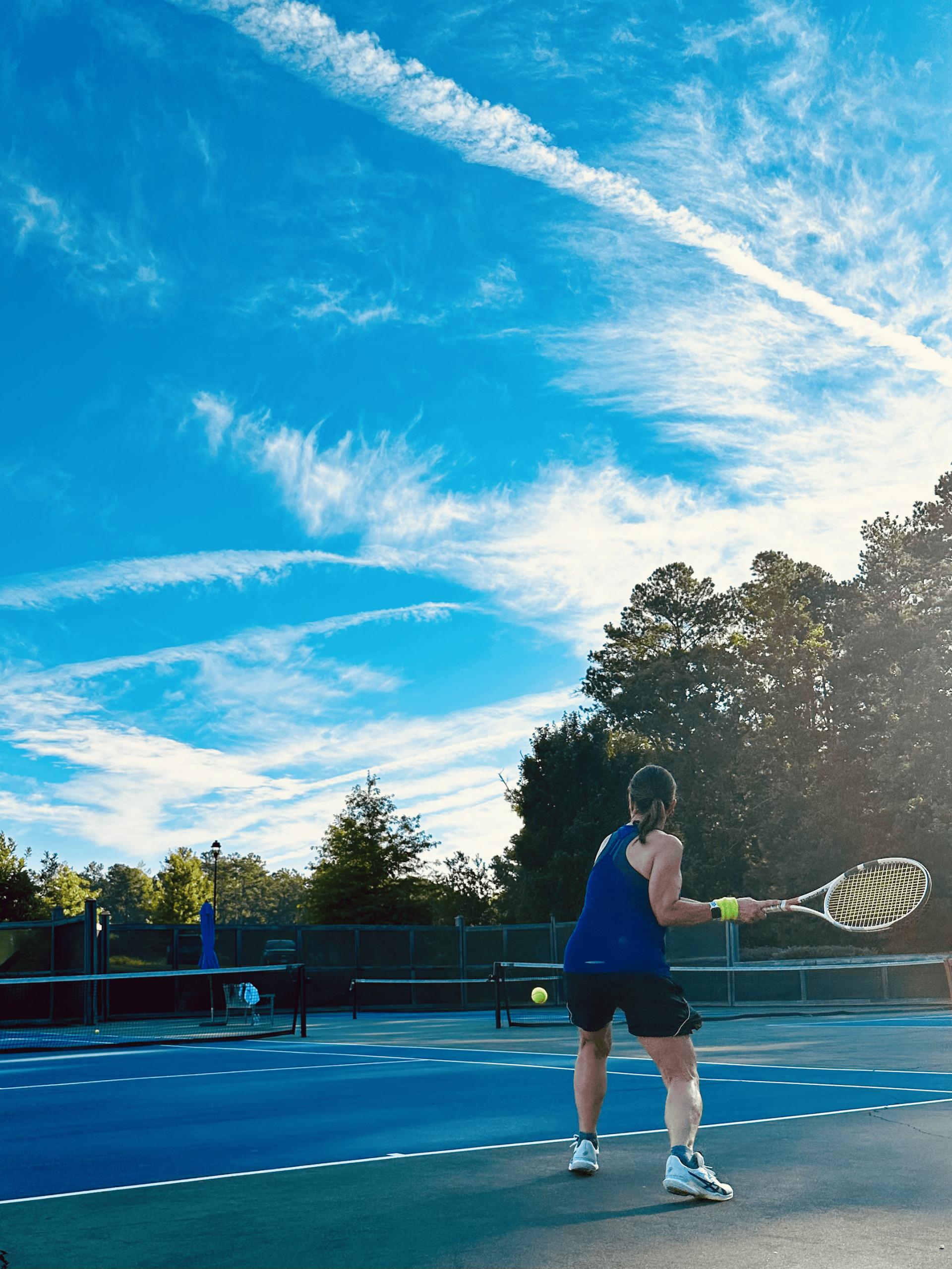 a woman playing tennis on a tennis court