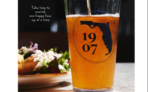 a glass of beer and a plate of salad