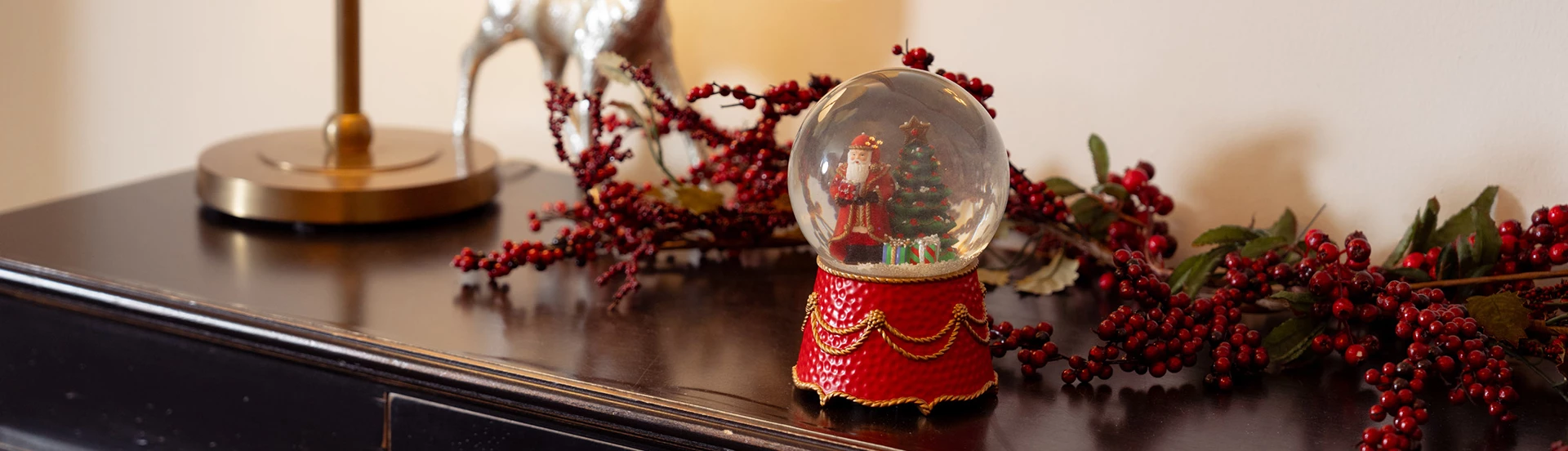 a snow globe with a santa claus and a christmas tree inside