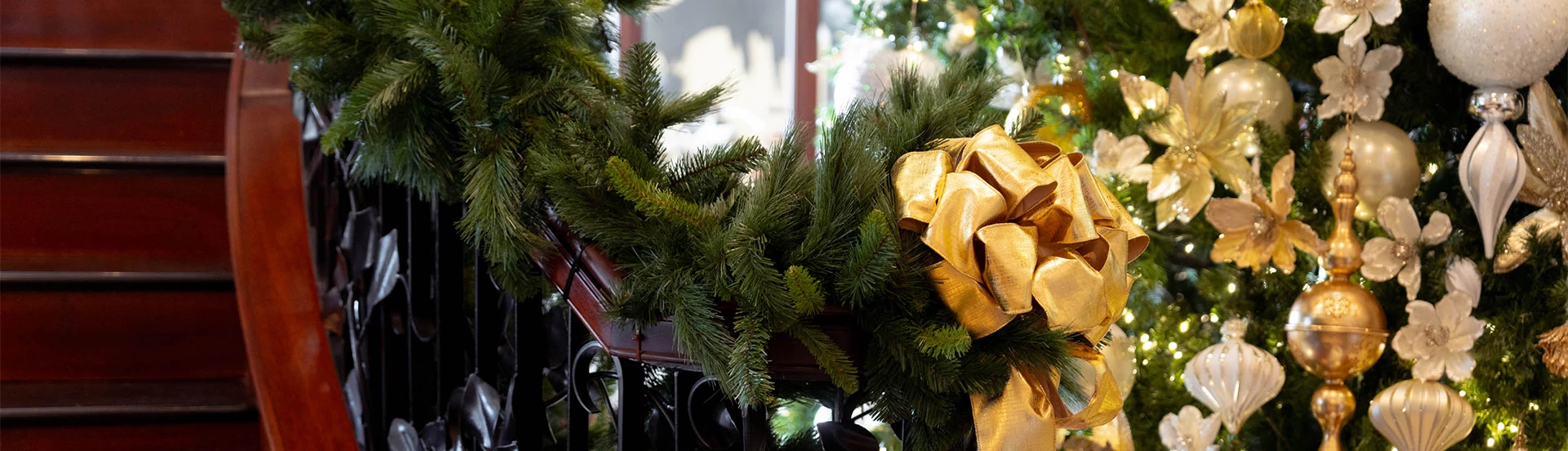 a wreath with a gold bow on top of it
