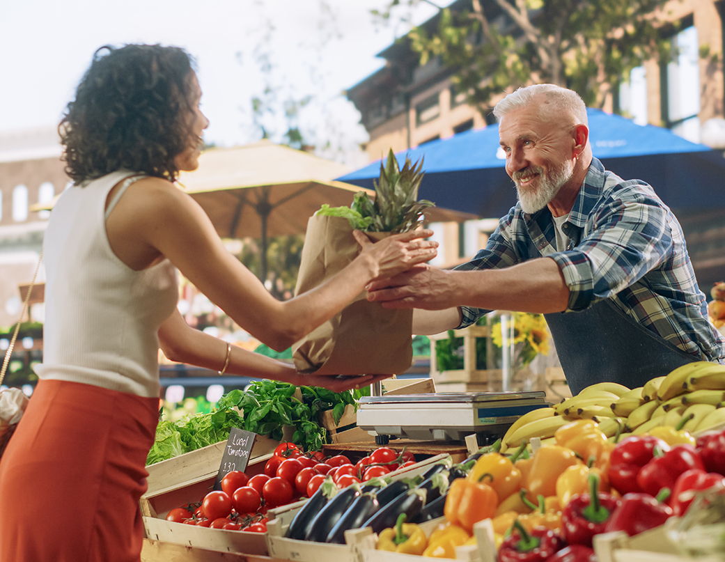 a man handing a bag of food to a woman