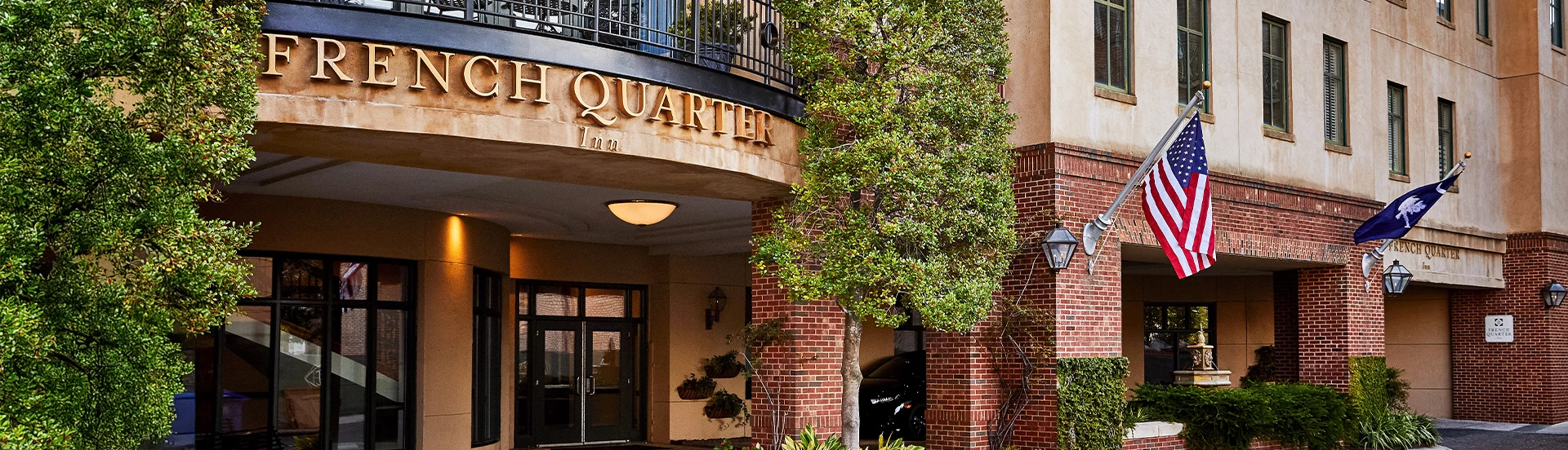 a building with a tree and a sign
