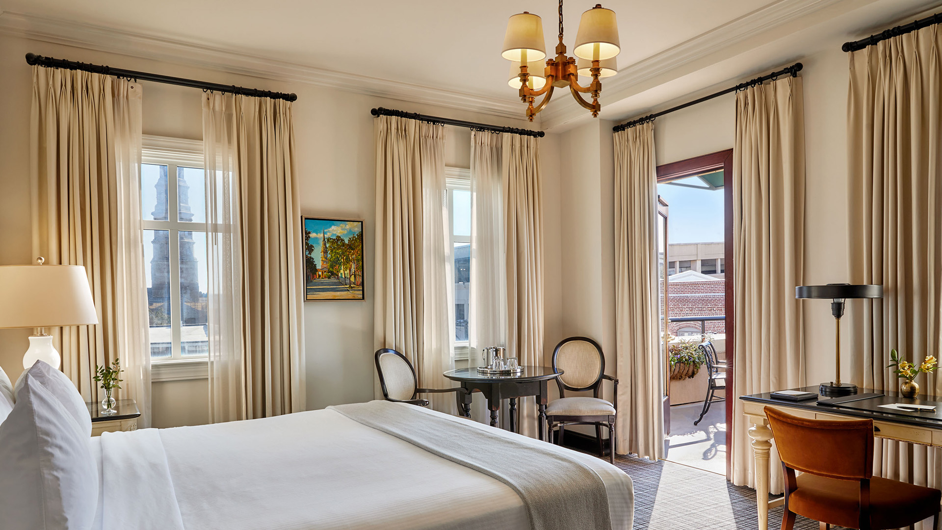 a room with a bed and chairs and a table