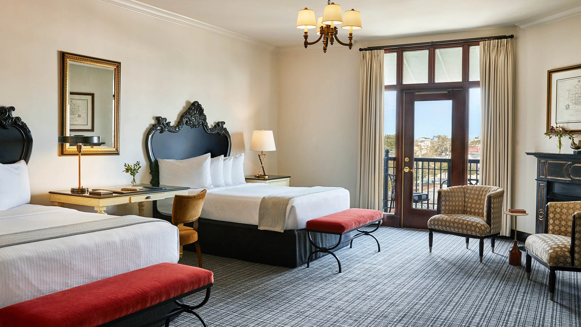 a room with a bed and chairs