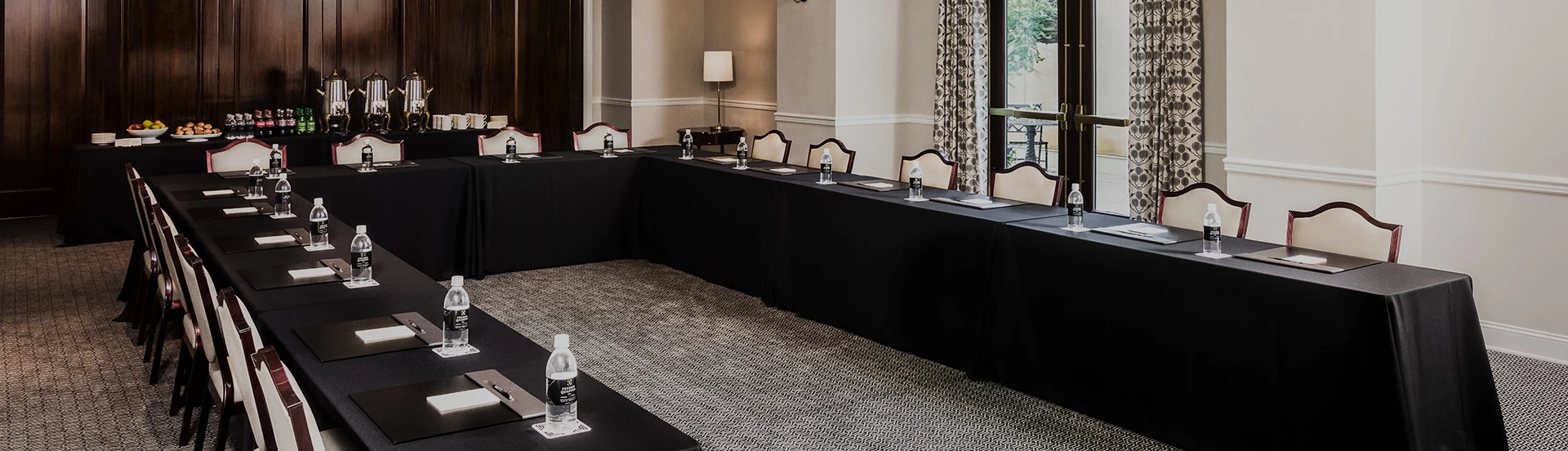 a long table with black tablecloths and a black tablecloth