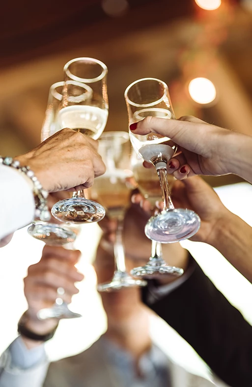 a group of people clinking wine glasses