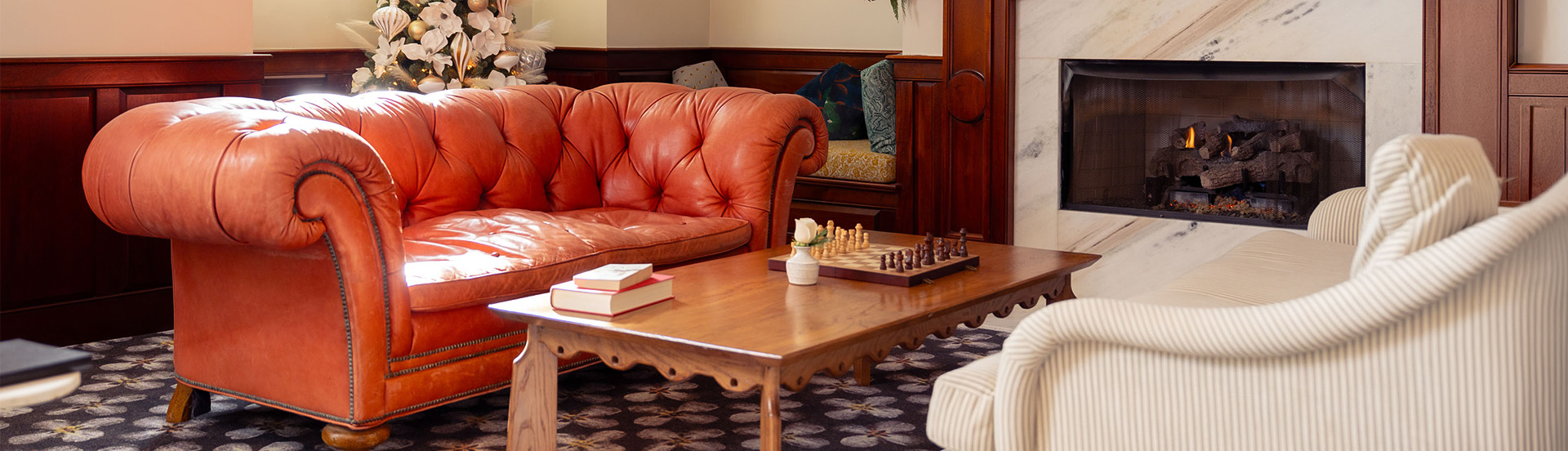a couch and a chess board on a coffee table