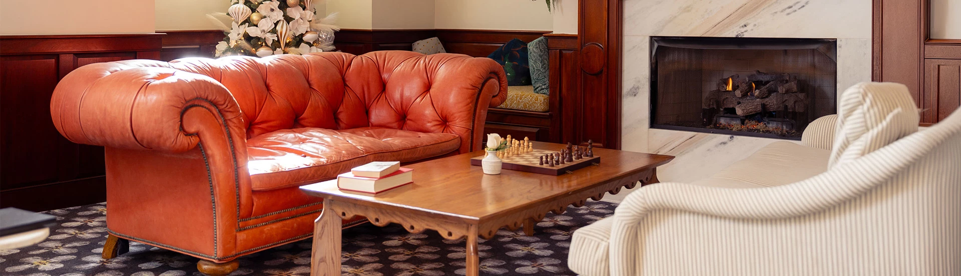 a couch and a chess board on a coffee table