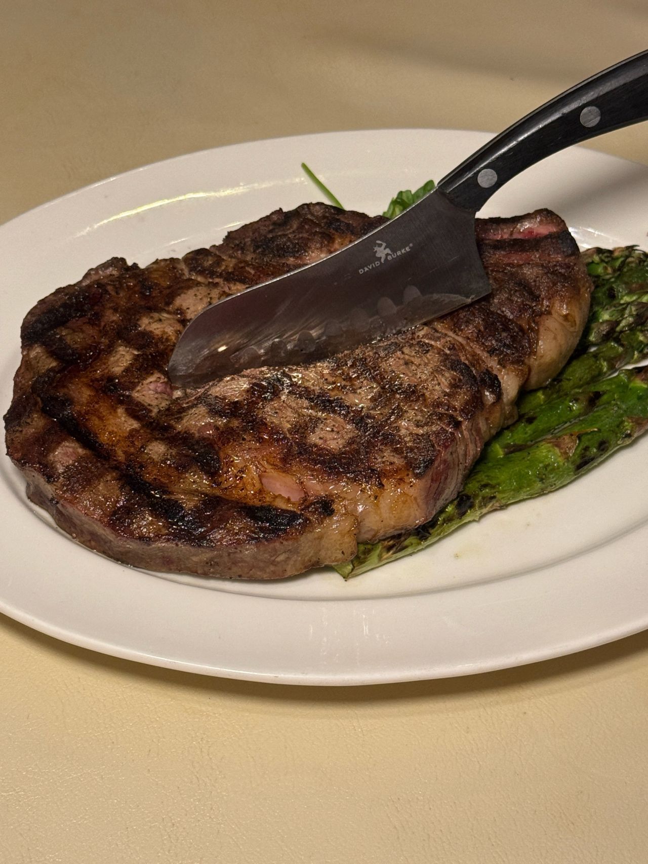 a steak and asparagus on a plate