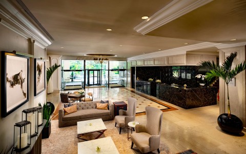 a lobby with a reception desk and chairs