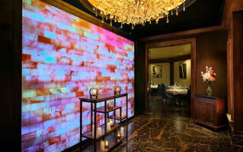 a room with a chandelier and a wall