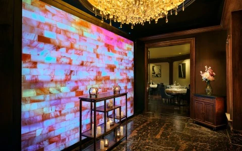 a room with a chandelier and a wall