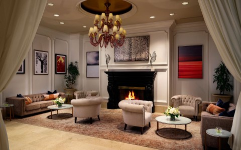 a room with a fireplace and chairs